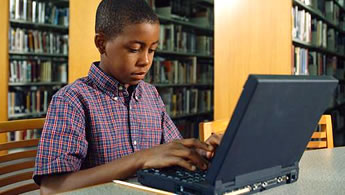 image of a boy using a laptop